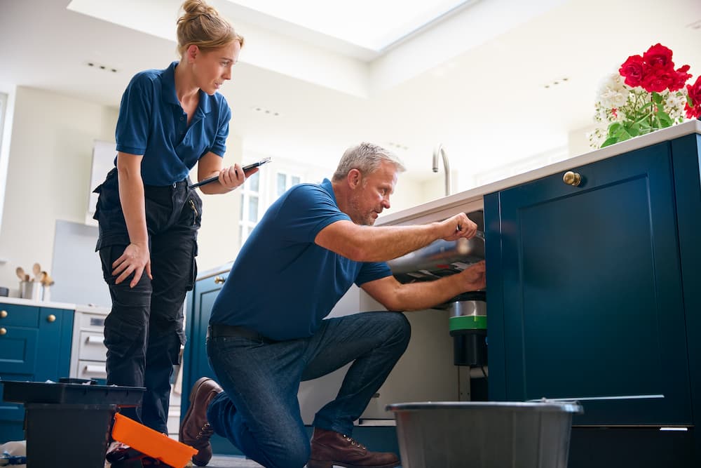 male-plumber-with-female-trainee-using-digital-tab-2024-10-20-19-59-49-utc-1.jpg
